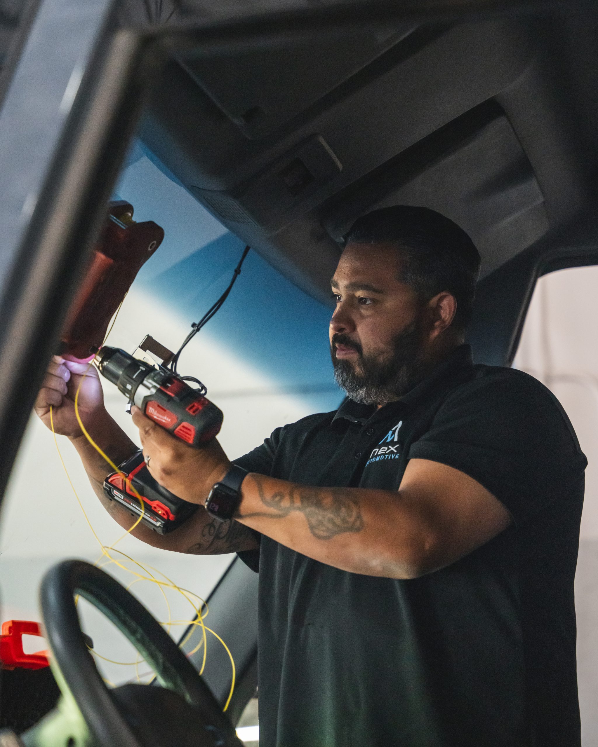 nex automotive team member performing a windshield replacement in rocklin ca